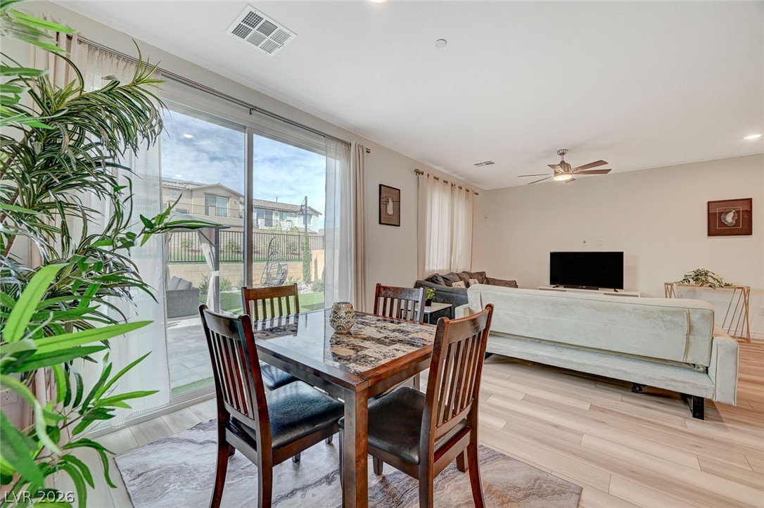 8855 Roadrunner Ravine Street Las Vegas, NV 89166 - Photo 22 of 54 Dining space featuring light wood-style floors, ceiling fan, and visible vents
