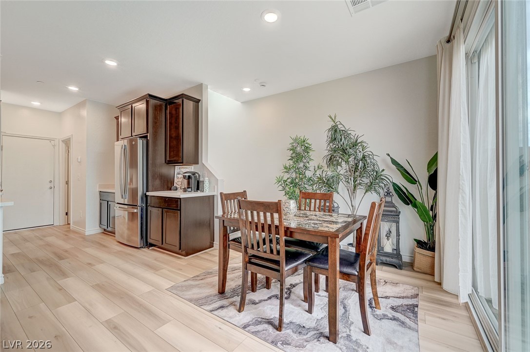 8855 Roadrunner Ravine Street Las Vegas, NV 89166 - Photo 23 of 54 Dining room featuring light wood finished floors, baseboards, and recessed lighting