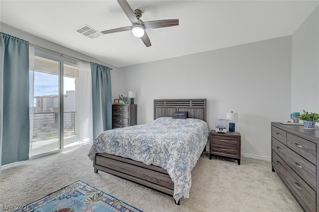 8855 Roadrunner Ravine Street Las Vegas, NV 89166 - Photo 29 of 54 Bedroom with access to exterior, baseboards, visible vents, and light colored carpet