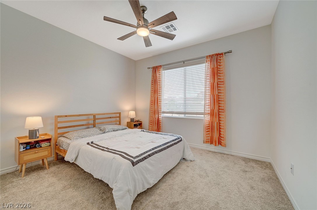 8855 Roadrunner Ravine Street Las Vegas, NV 89166 - Photo 30 of 54 Bedroom featuring ceiling fan, carpet flooring, visible vents, and baseboards