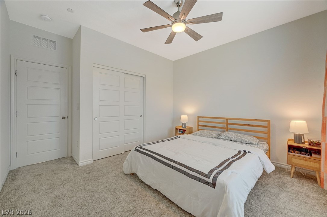 8855 Roadrunner Ravine Street Las Vegas, NV 89166 - Photo 31 of 54 Bedroom featuring carpet, a closet, visible vents, a ceiling fan, and baseboards