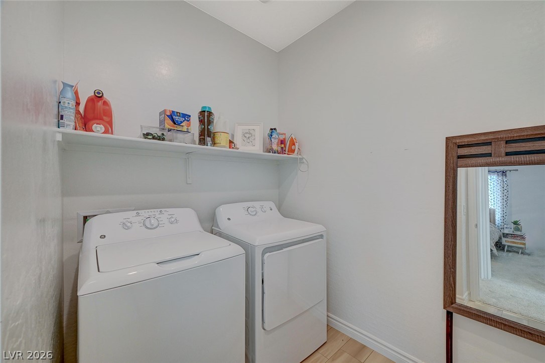 8855 Roadrunner Ravine Street Las Vegas, NV 89166 - Photo 35 of 54 Washroom with laundry area, independent washer and dryer, light wood-style flooring, and baseboards
