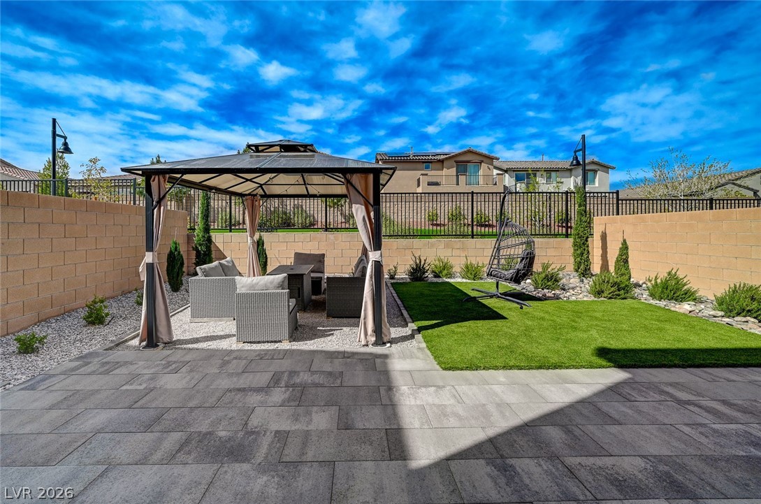8855 Roadrunner Ravine Street Las Vegas, NV 89166 - Photo 42 of 54 View of patio / terrace featuring a gazebo, a fenced backyard, and an outdoor living space