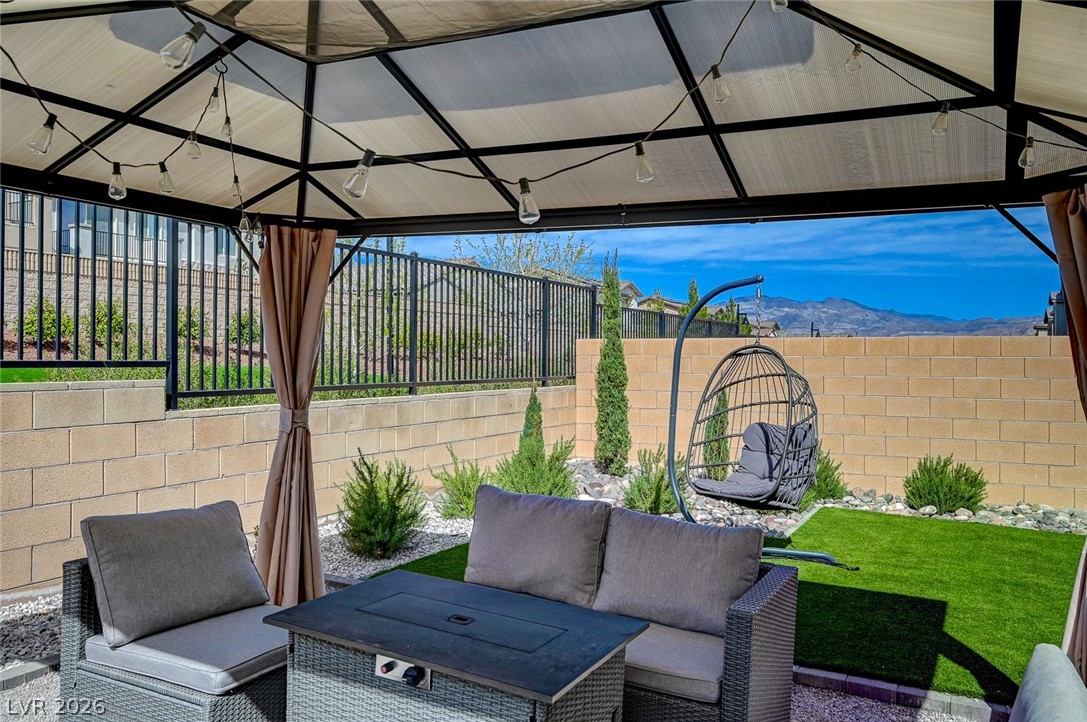 8855 Roadrunner Ravine Street Las Vegas, NV 89166 - Photo 43 of 54 View of patio / terrace featuring a fenced backyard, a mountain view, an outdoor living space, and a gazebo