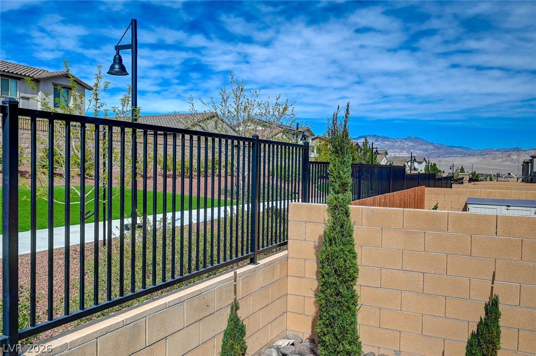 8855 Roadrunner Ravine Street Las Vegas, NV 89166 - Photo 49 of 54 View of gate with fence and a mountain view
