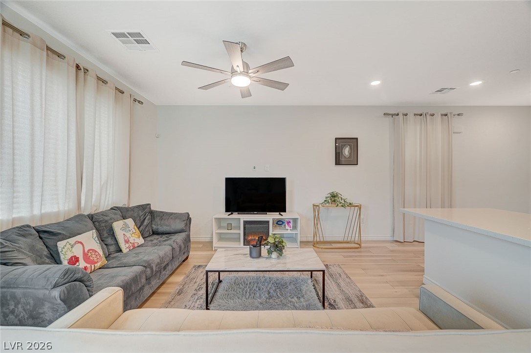 8855 Roadrunner Ravine Street Las Vegas, NV 89166 - Photo 8 of 54 Living area with light wood-style flooring, visible vents, ceiling fan, and recessed lighting