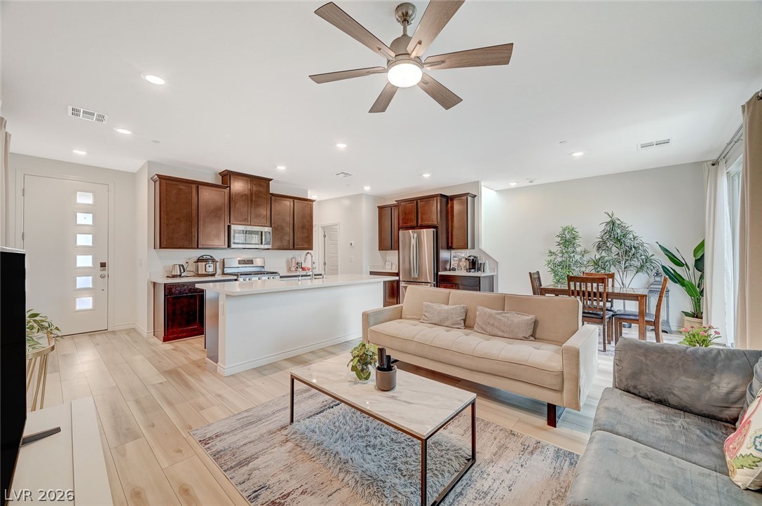 8855 Roadrunner Ravine Street Las Vegas, NV 89166 - Photo 10 of 54 Living room with recessed lighting, visible vents, and light wood finished floors