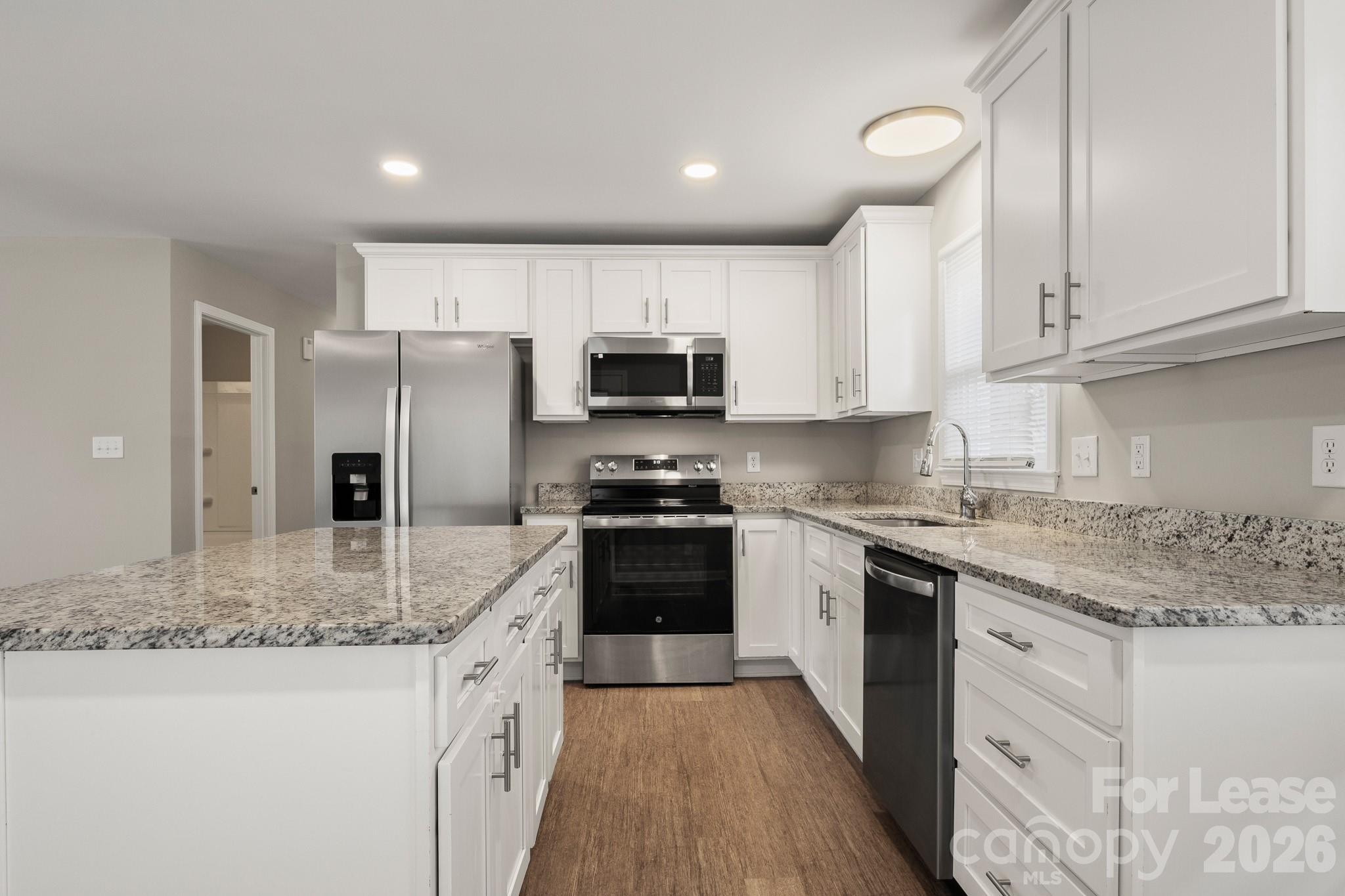 11805 Harrisburg Road Indian Land, SC 29707 - Photo 11 of 47 a kitchen with stainless steel appliances granite countertop a stove refrigerator sink and microwave