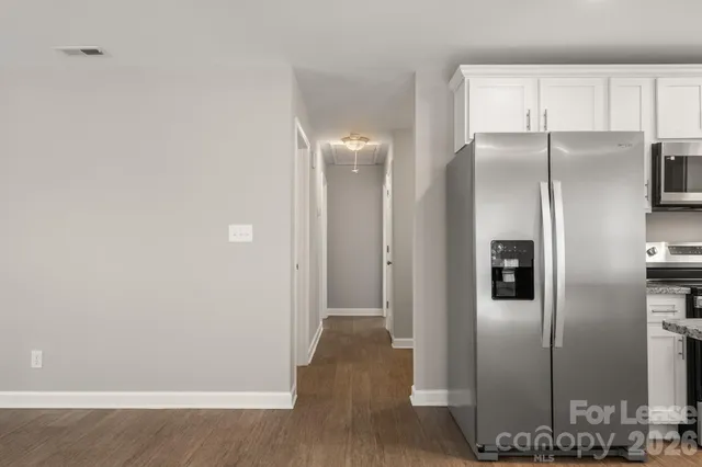 a view of a kitchen with wooden floor