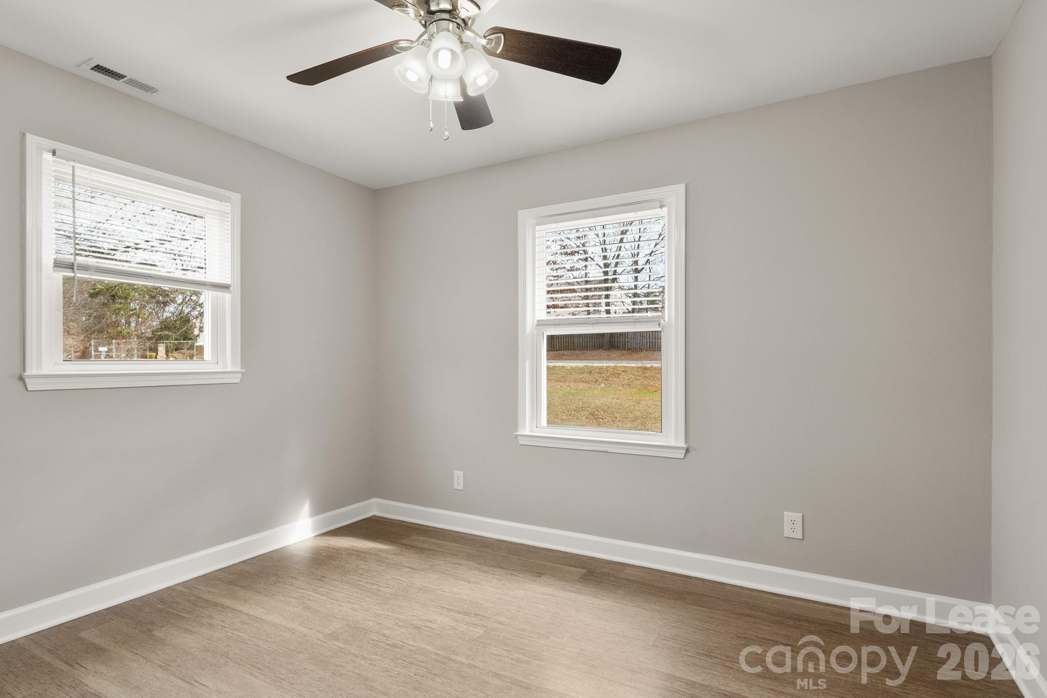 11805 Harrisburg Road Indian Land, SC 29707 - Photo 20 of 47 a view of an empty room with a window and wooden floor
