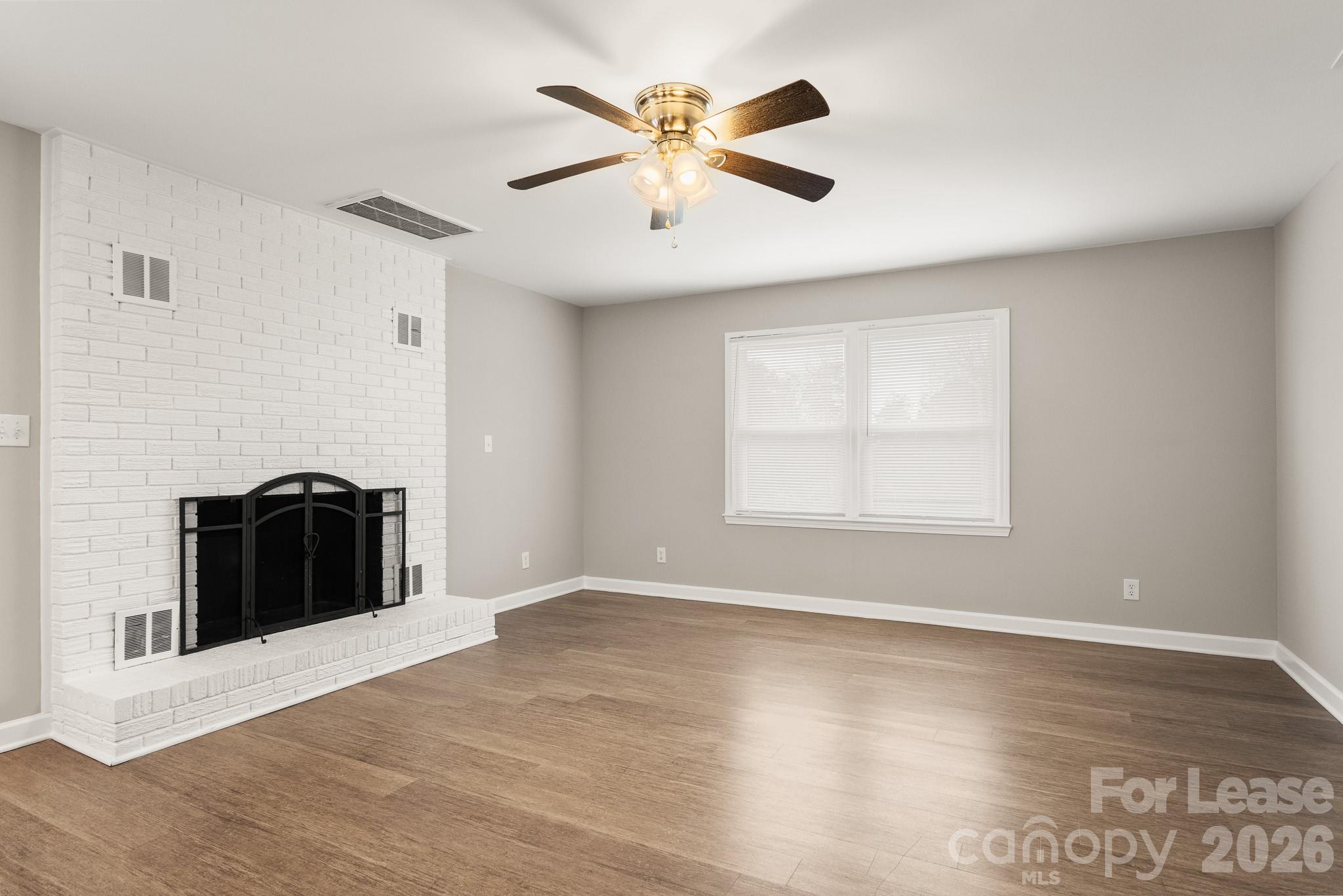 11805 Harrisburg Road Indian Land, SC 29707 - Photo 8 of 47 a view of a livingroom with a ceiling fan and wooden floor
