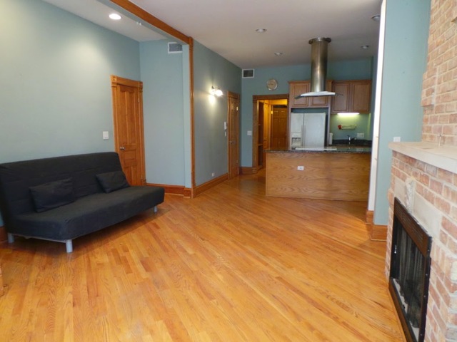 1231 North Artesian Avenue, Unit 2 Chicago, IL 60622 - Photo 3 of 9 a living room with a couch and a fireplace
