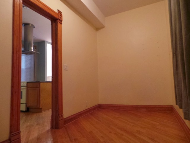 1231 North Artesian Avenue, Unit 2 Chicago, IL 60622 - Photo 6 of 9 an empty room with wooden floor and windows