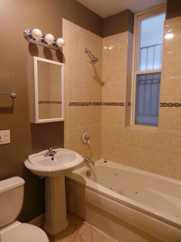1231 North Artesian Avenue, Unit 2 Chicago, IL 60622 - Photo 7 of 9 a bathroom with a sink toilet and shower