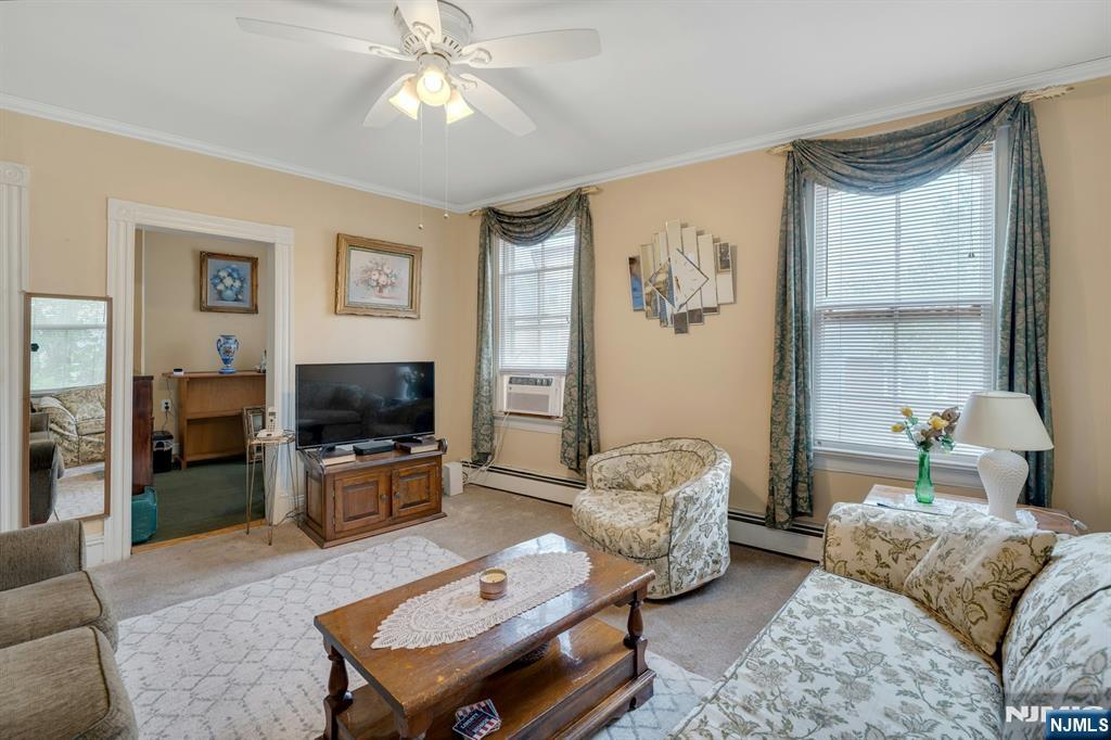 79 Washington Street Harrison, NJ 07029 - Photo 10 of 25 a living room with furniture a flat screen tv and a window