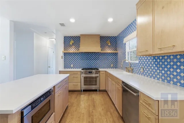 a kitchen with a sink stove and cabinets