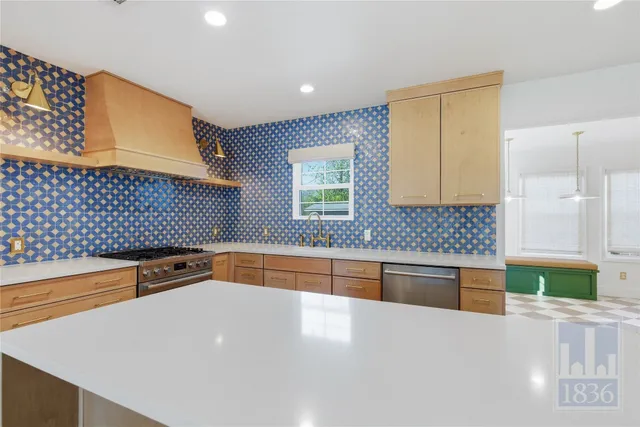 a kitchen with stainless steel appliances granite countertop a sink and a granite counter tops