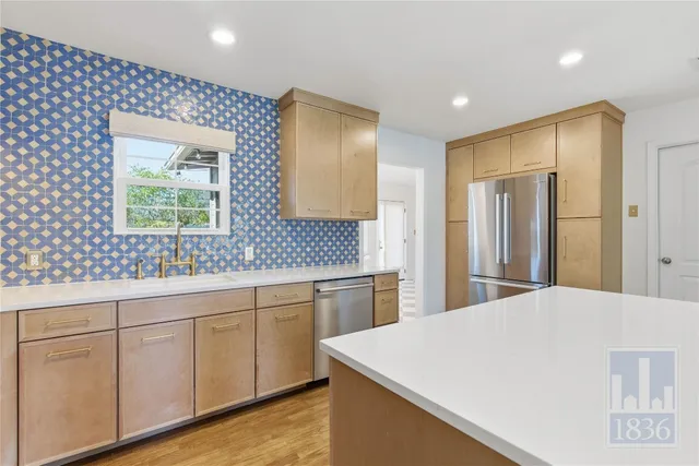a kitchen with a sink cabinets and wooden floor