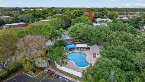 an aerial view of a house with a yard and outdoor seating