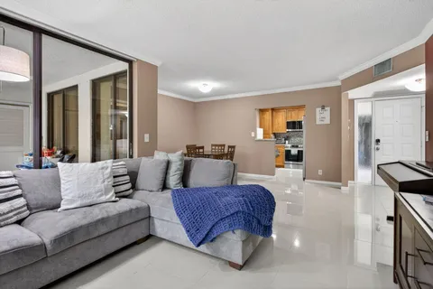 a living room with furniture and a large mirror