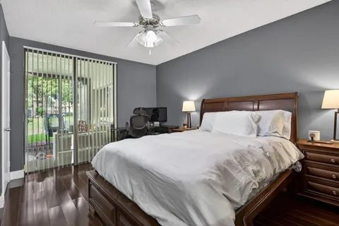 a bedroom with a balcony a bed and a chandelier