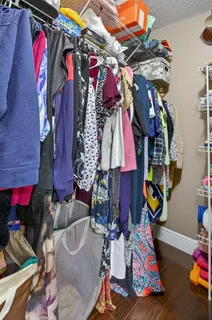 a view of walk in closet with clothes and shoes