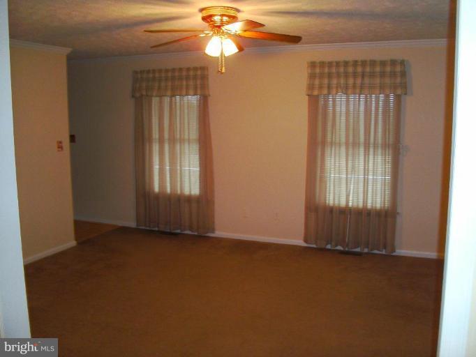 121 Minebank Road Middletown, VA 22645 - Photo 14 of 26 an empty room with windows and chandelier fan