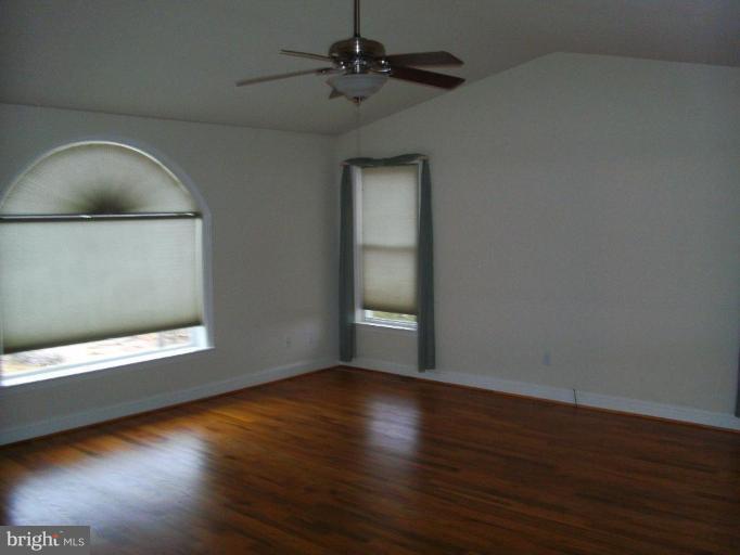 121 Minebank Road Middletown, VA 22645 - Photo 16 of 26 a view of an empty room with wooden floor and a window