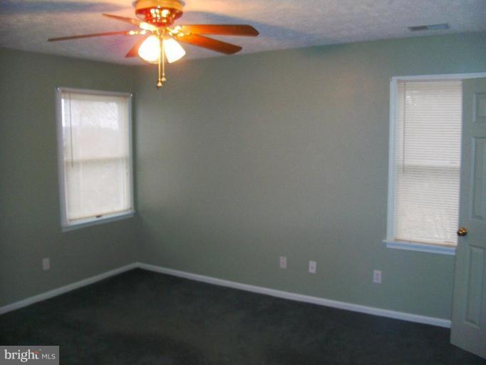121 Minebank Road Middletown, VA 22645 - Photo 17 of 26 an empty room with a window and a fan