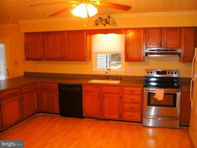 121 Minebank Road Middletown, VA 22645 - Photo 10 of 26 a kitchen with stainless steel appliances granite countertop a stove a sink and a microwave