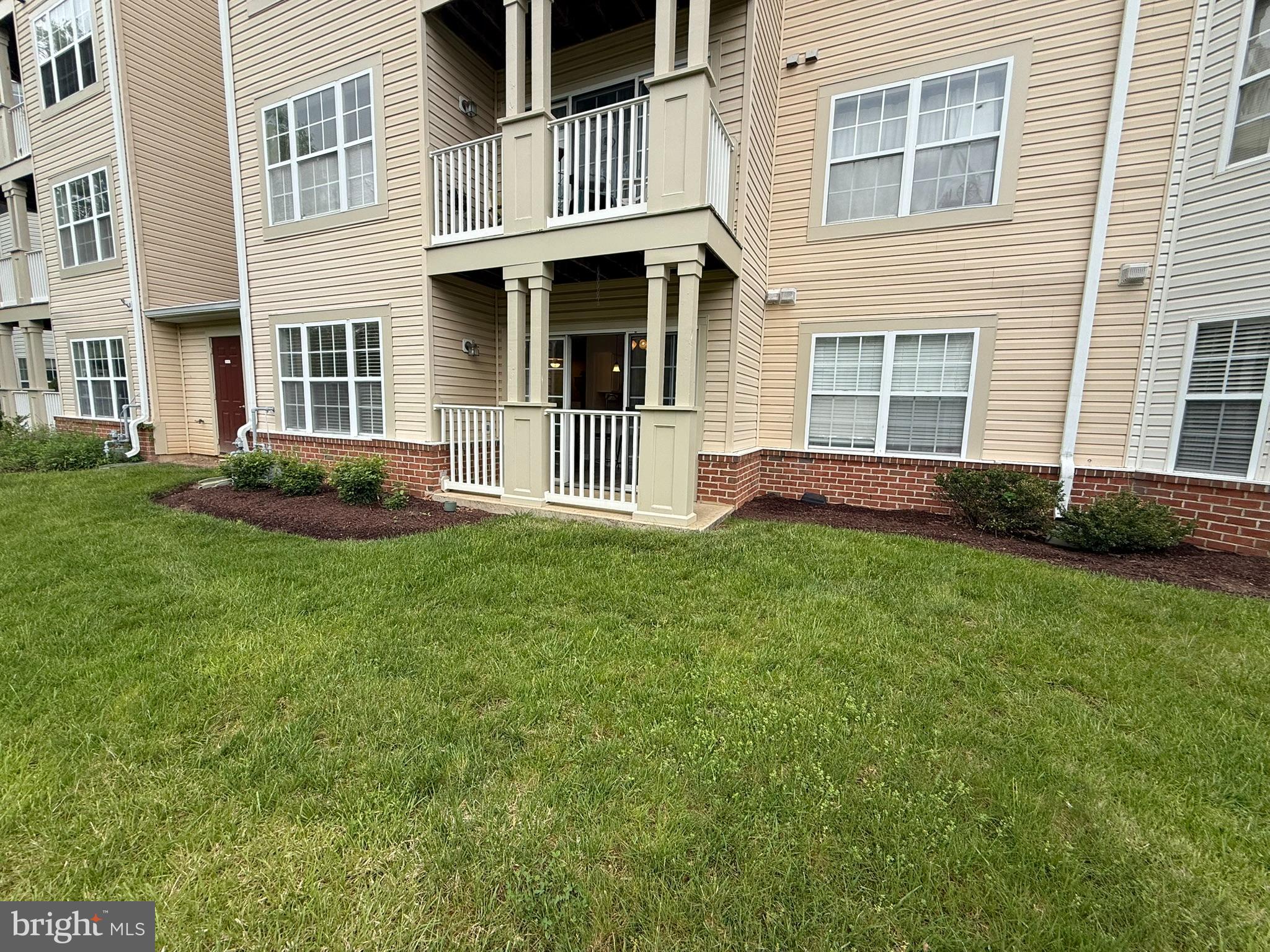 6343 Springwater Terrace, Unit 1012 Frederick, MD 21701 - Photo 16 of 39 a front view of a house with a yard