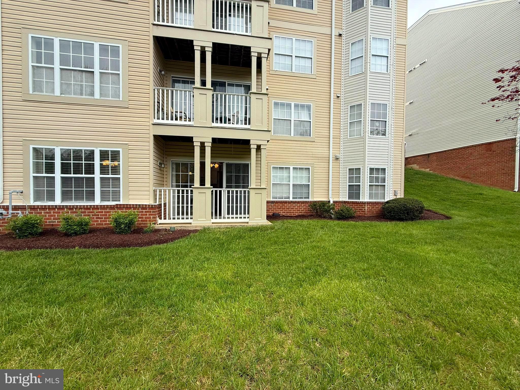 6343 Springwater Terrace, Unit 1012 Frederick, MD 21701 - Photo 17 of 39 a front view of a house with a yard