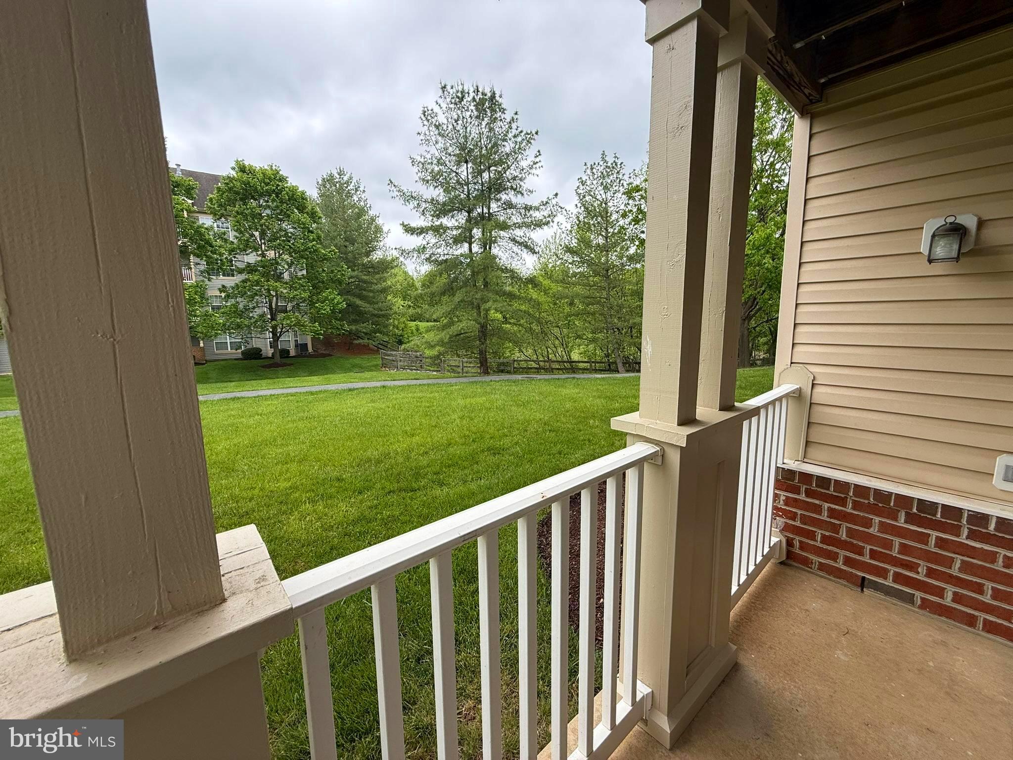 6343 Springwater Terrace, Unit 1012 Frederick, MD 21701 - Photo 19 of 39 a view of a porch with a yard