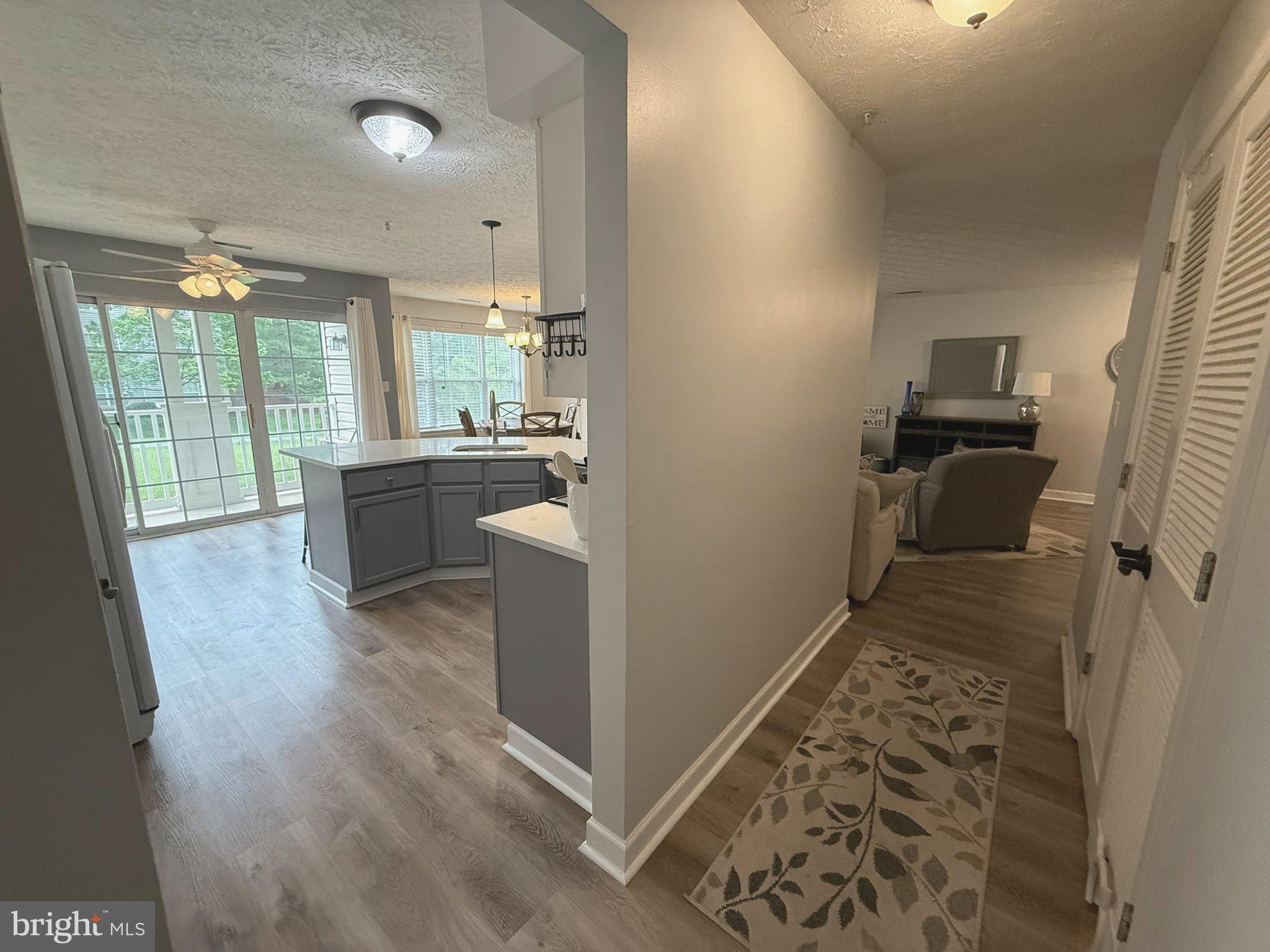 6343 Springwater Terrace, Unit 1012 Frederick, MD 21701 - Photo 22 of 39 a room with wooden floor and furniture