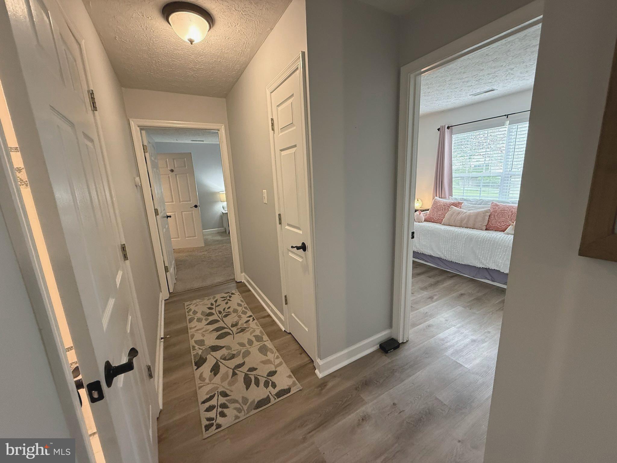 6343 Springwater Terrace, Unit 1012 Frederick, MD 21701 - Photo 25 of 39 a view of a hallway view with wooden floor and staircase