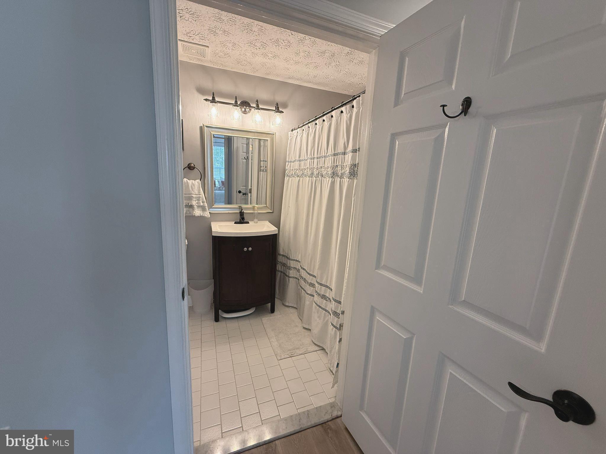 6343 Springwater Terrace, Unit 1012 Frederick, MD 21701 - Photo 28 of 39 a bathroom with a sink a toilet and shower