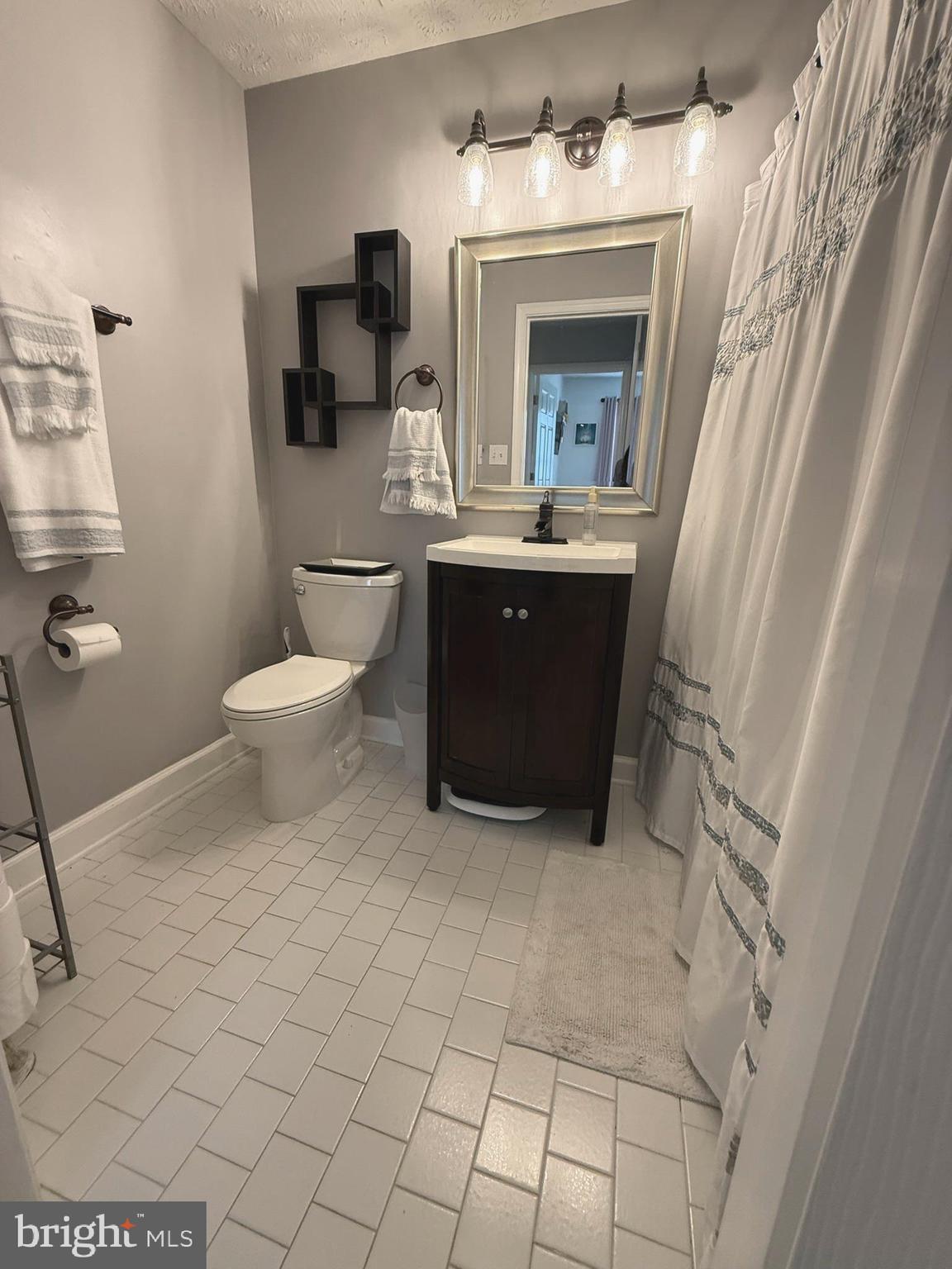 6343 Springwater Terrace, Unit 1012 Frederick, MD 21701 - Photo 29 of 39 a bathroom with a sink a toilet and mirror