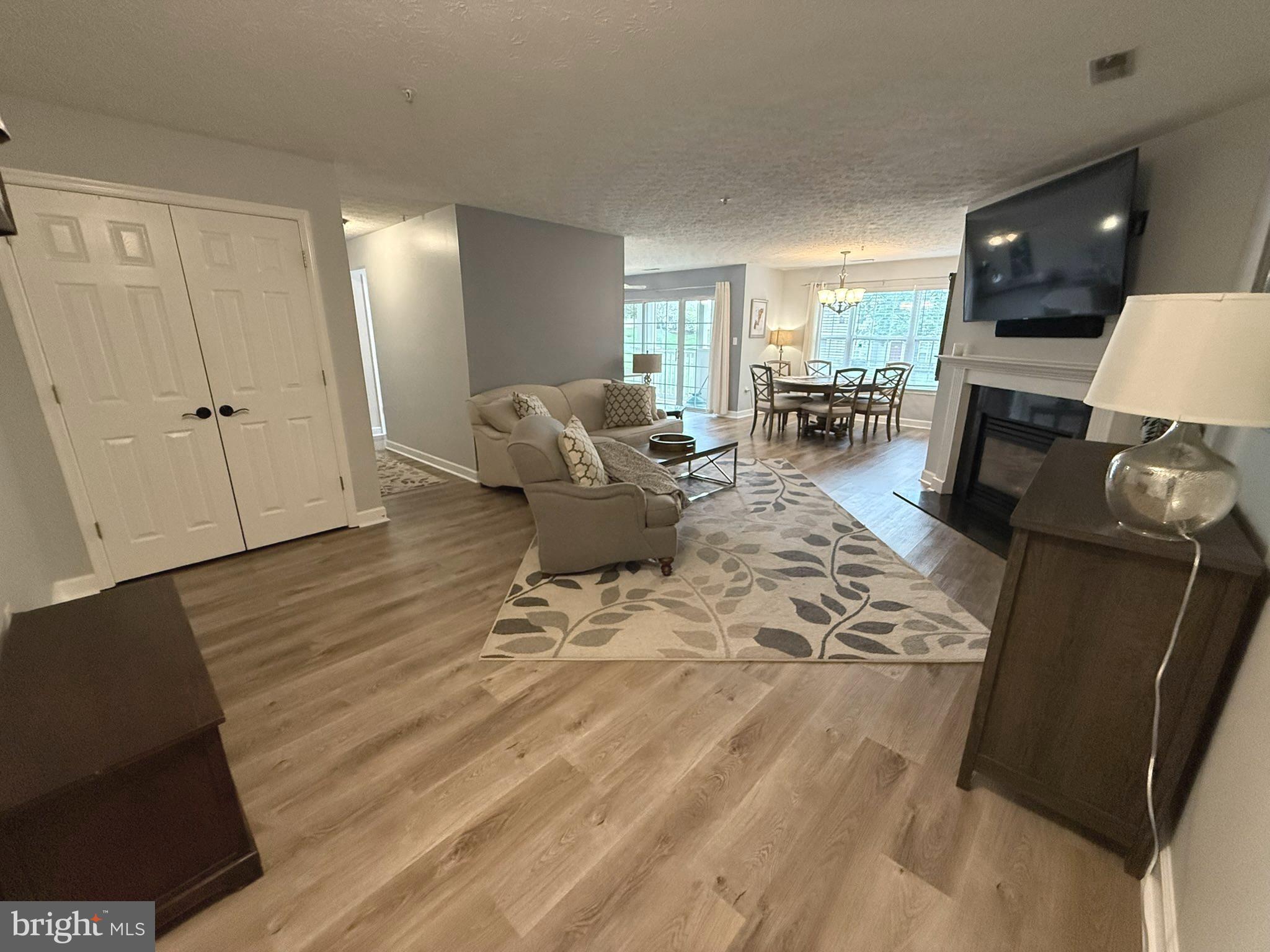 6343 Springwater Terrace, Unit 1012 Frederick, MD 21701 - Photo 3 of 39 a living room with furniture and a flat screen tv