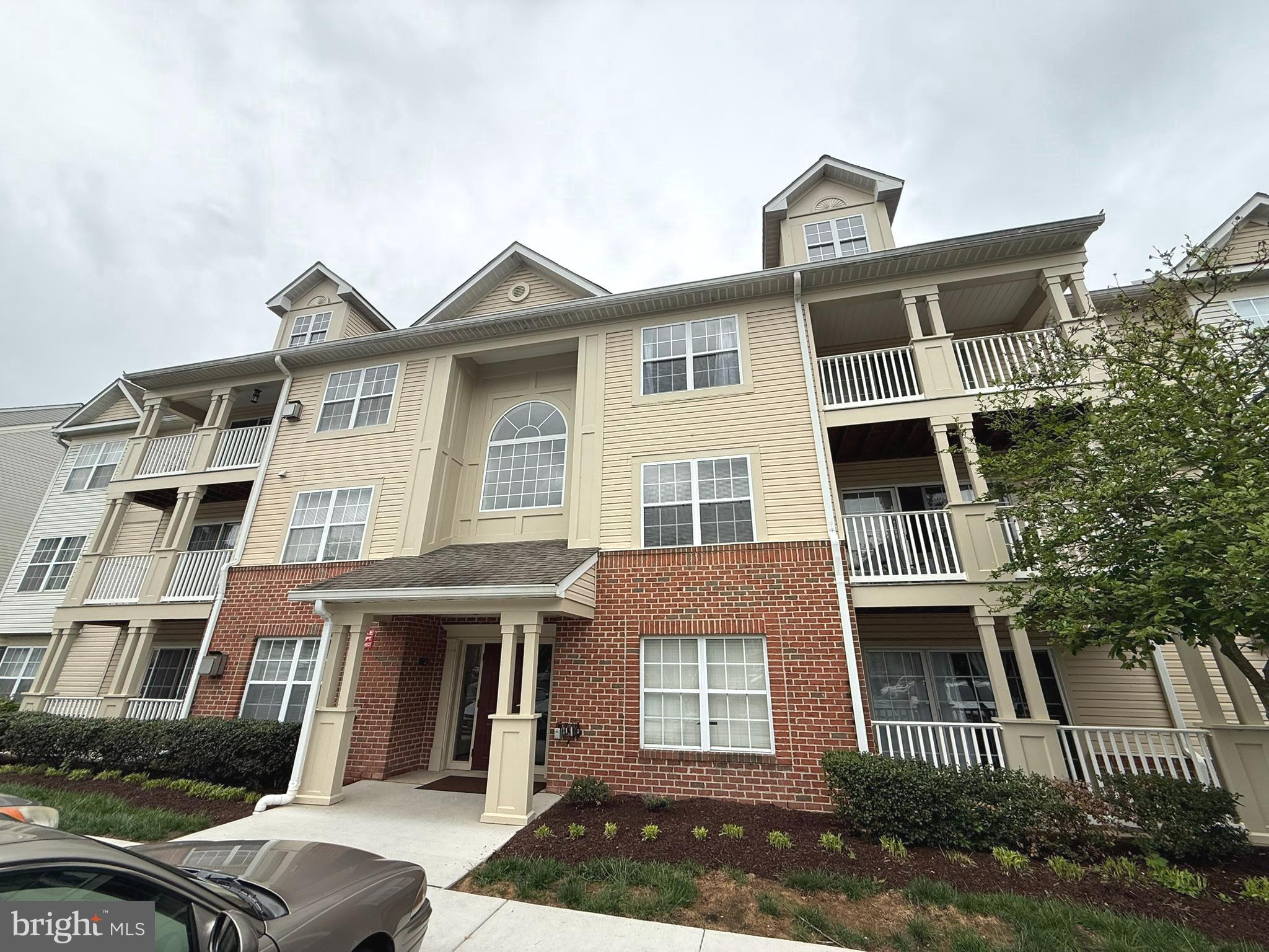6343 Springwater Terrace, Unit 1012 Frederick, MD 21701 - Photo 35 of 39 a front view of a house with a yard