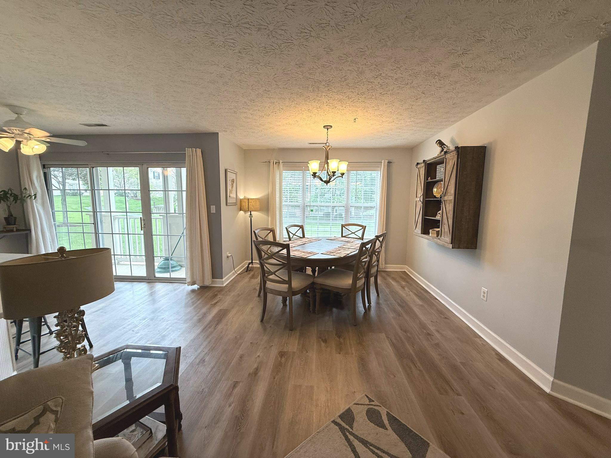 6343 Springwater Terrace, Unit 1012 Frederick, MD 21701 - Photo 7 of 39 a view of a dining room with furniture window and wooden floor