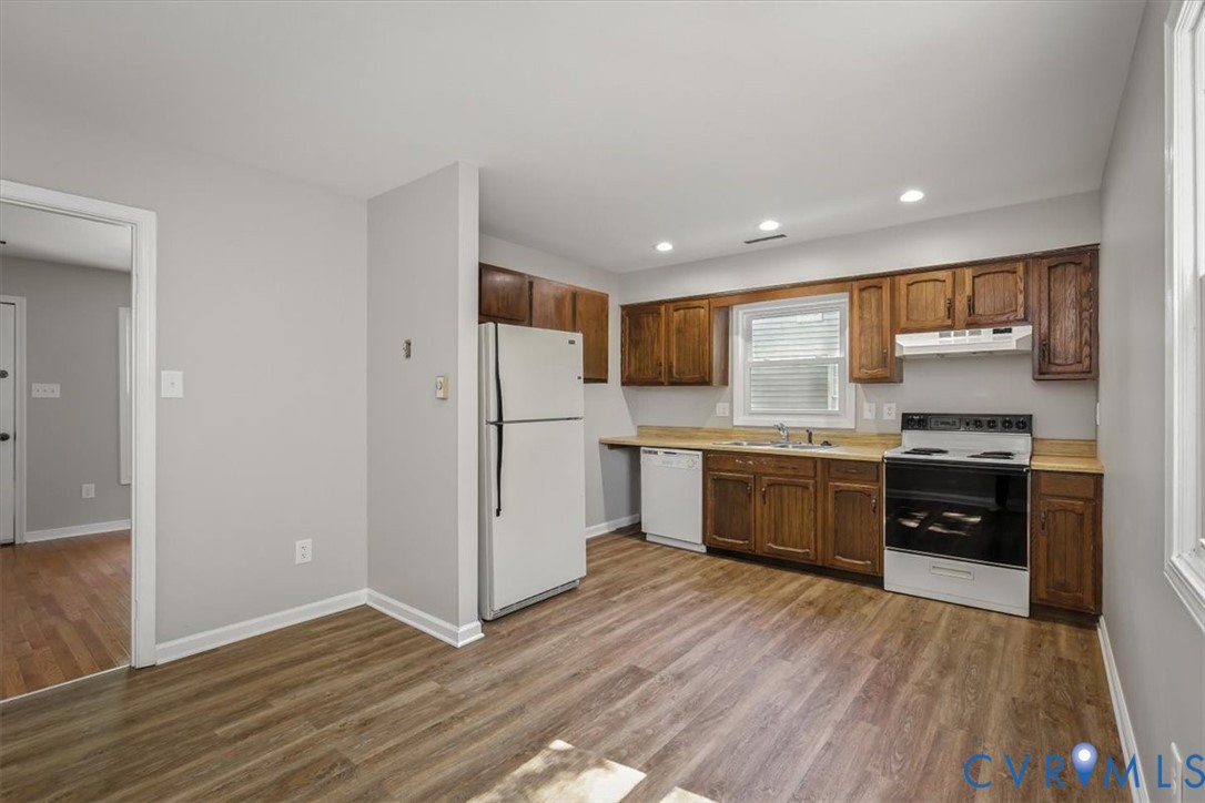 8522 Rainwater Road Richmond, VA 23237 - Photo 17 of 44 Kitchen with white appliances, light countertops,