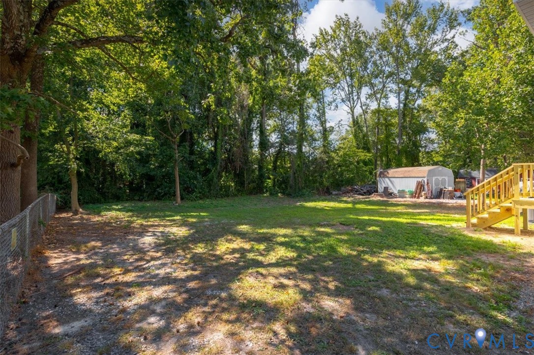 8522 Rainwater Road Richmond, VA 23237 - Photo 41 of 44 View of yard with a storage unit and stairway