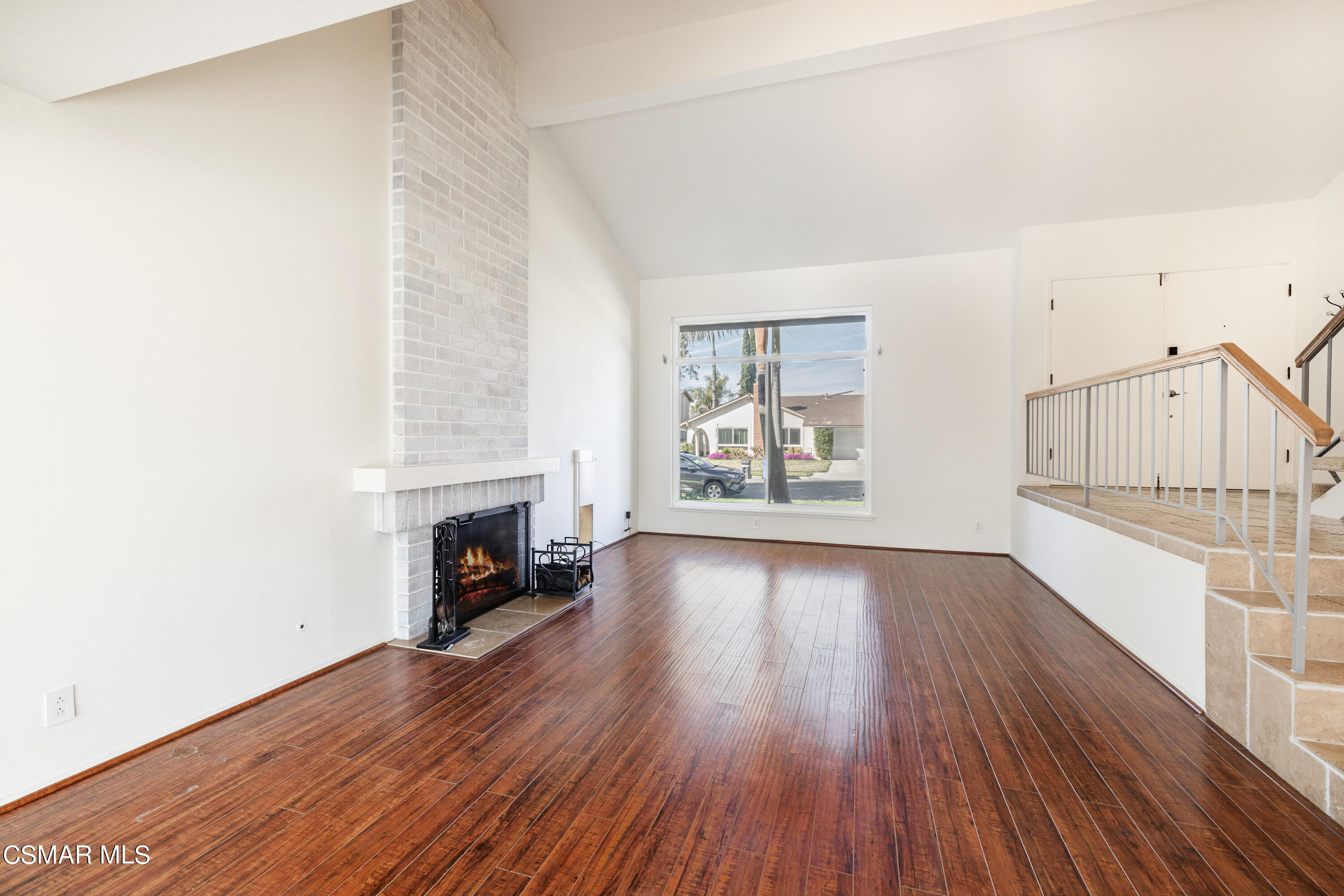 2456 Victoria Street Simi Valley, CA 93065 - Photo 4 of 24 an empty room with wooden floor fireplace and windows