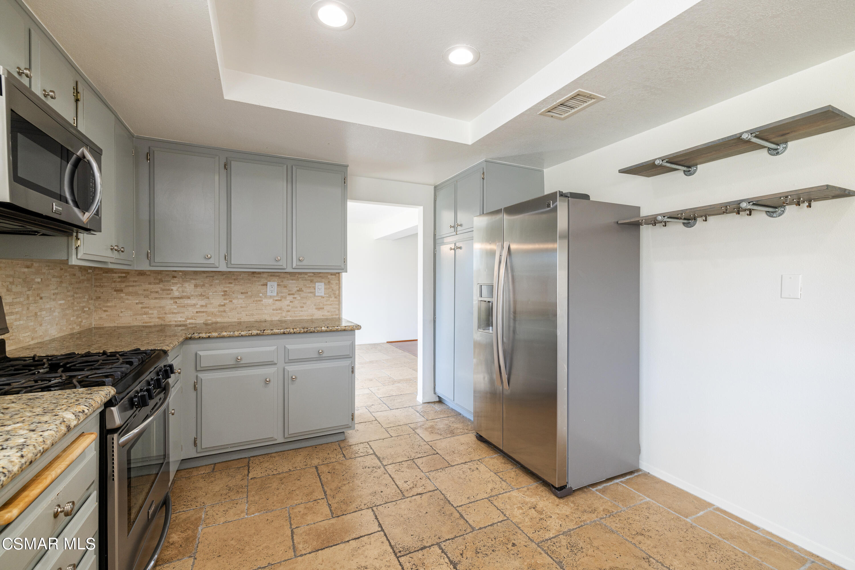 2456 Victoria Street Simi Valley, CA 93065 - Photo 9 of 24 a kitchen with stainless steel appliances granite countertop a refrigerator and a stove top oven