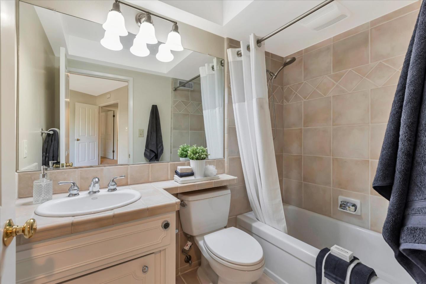 18400 Overlook Road, Unit 35 Los Gatos, CA 95030 - Photo 17 of 28 a bathroom with a sink a toilet a mirror a vanity and shower