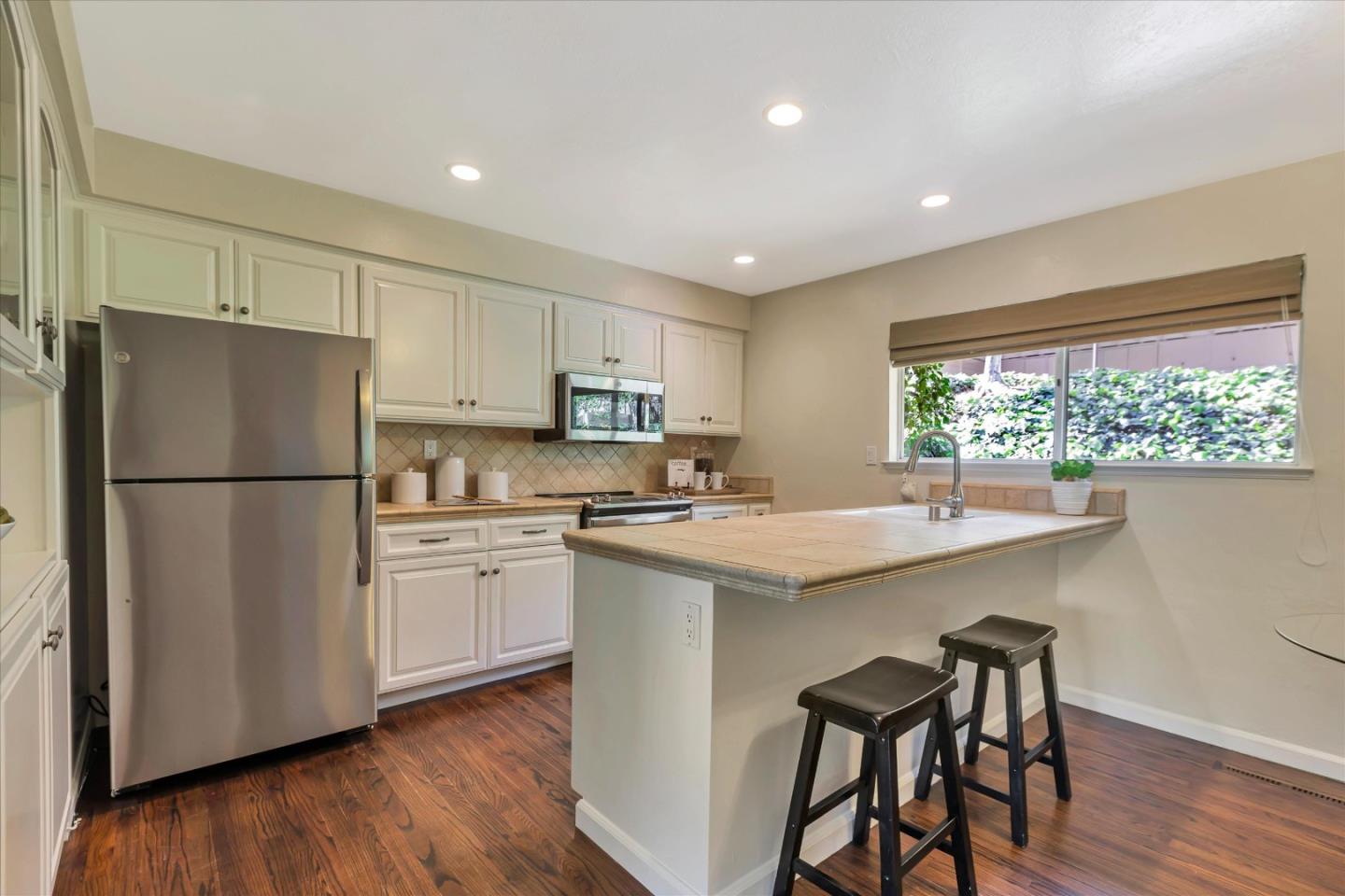 18400 Overlook Road, Unit 35 Los Gatos, CA 95030 - Photo 7 of 28 a kitchen with white cabinets and white appliances