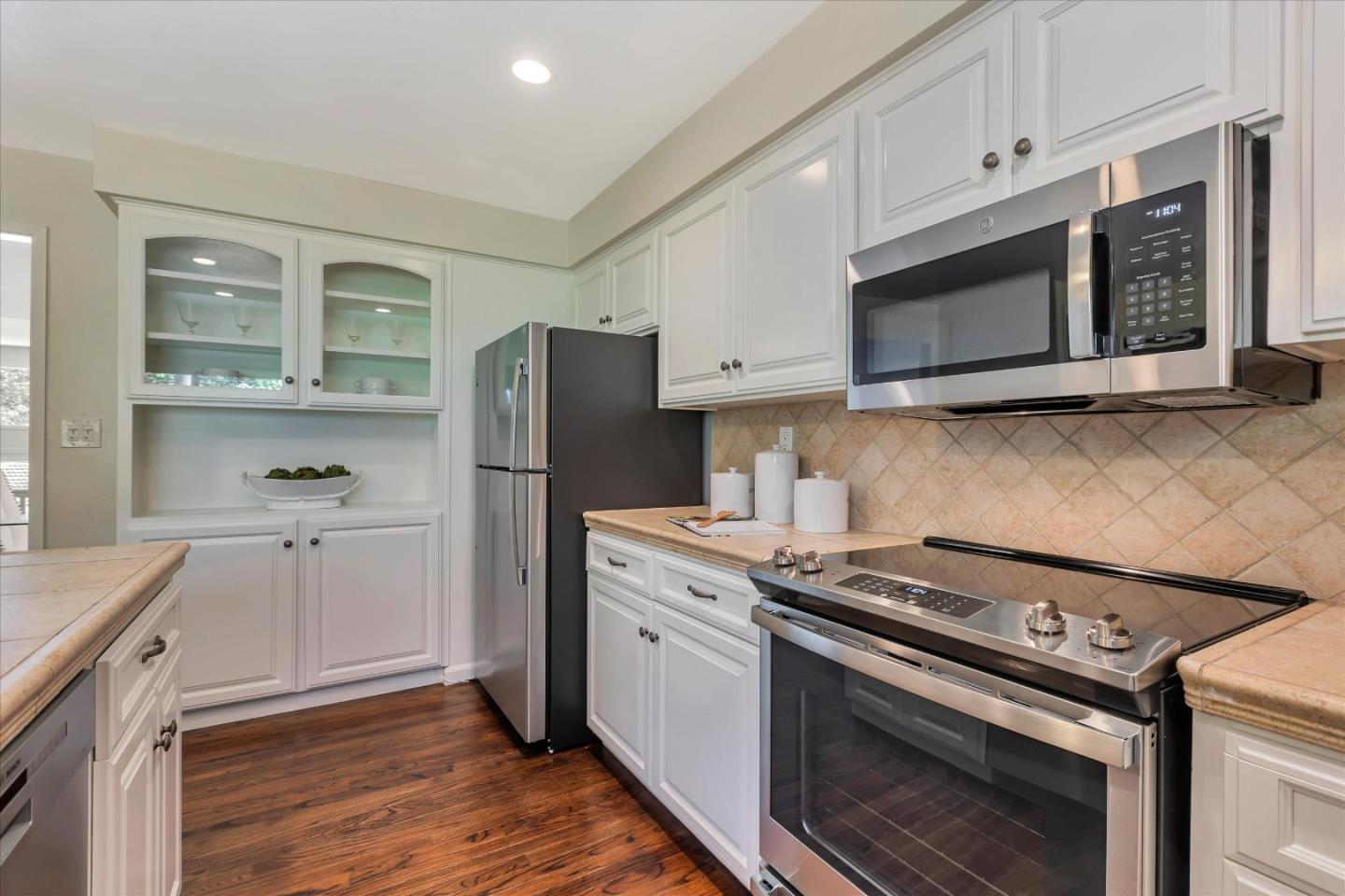 18400 Overlook Road, Unit 35 Los Gatos, CA 95030 - Photo 9 of 28 a kitchen with stainless steel appliances white cabinets and a stove top oven