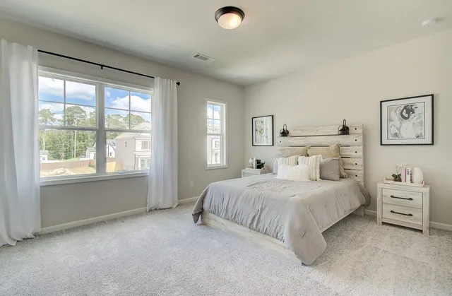 a bedroom with a bed and a large window