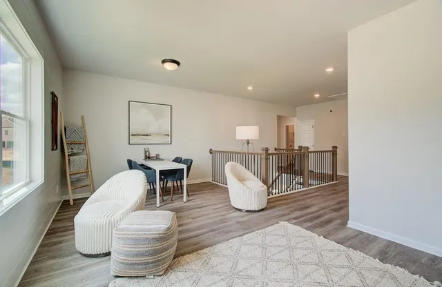 a living room with dining room and wooden floor