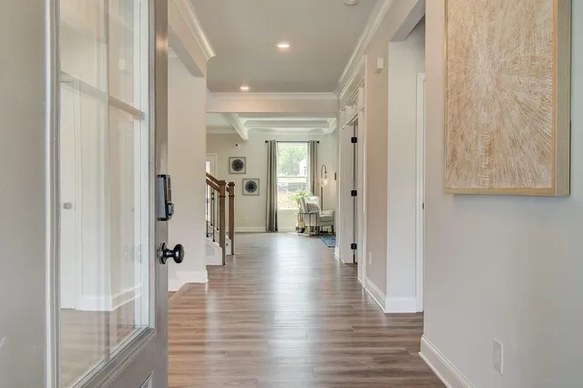 a view of a hallway with wooden floor and closet
